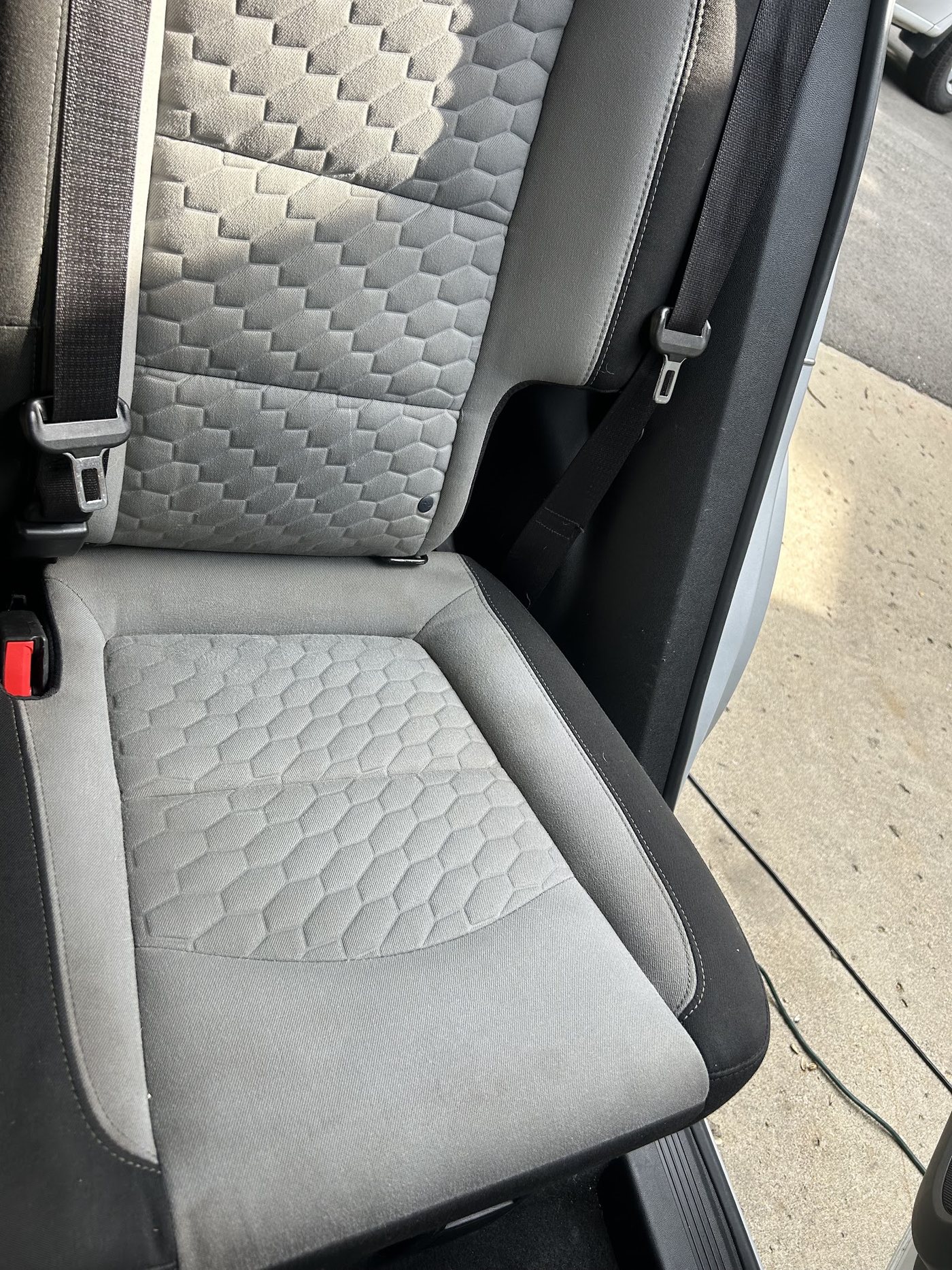 The same truck seat clean and even-toned after detailing
